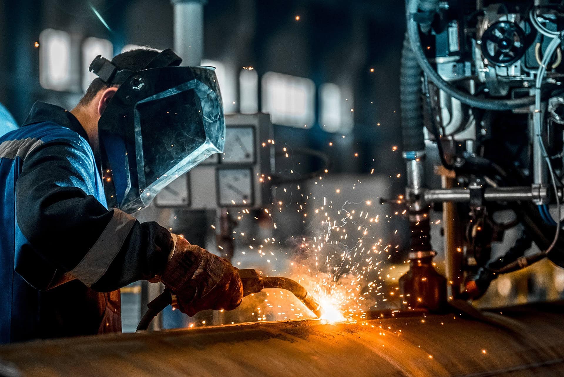 Worker performing a structural repair via welding.
